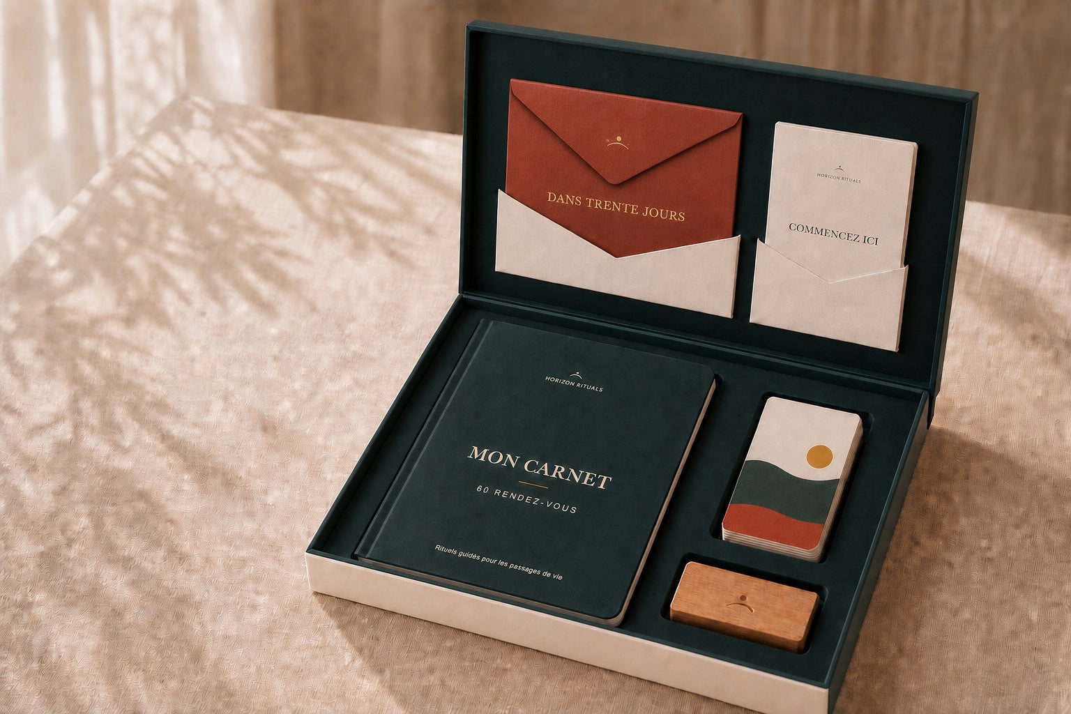 Coffret Horizon mononiveau ouvert avec le carnet, le porte-carte et la pile de cartes surmontée de sa carte d’ouverture illustrée, l’enveloppe et la notice
